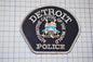 a detroit police patch sitting on top of a table