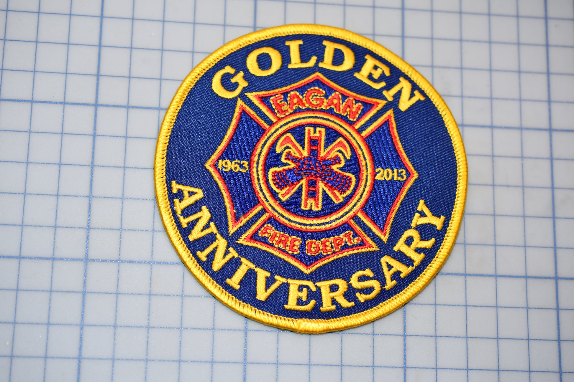 a blue and yellow patch with the words golden anniversary on it