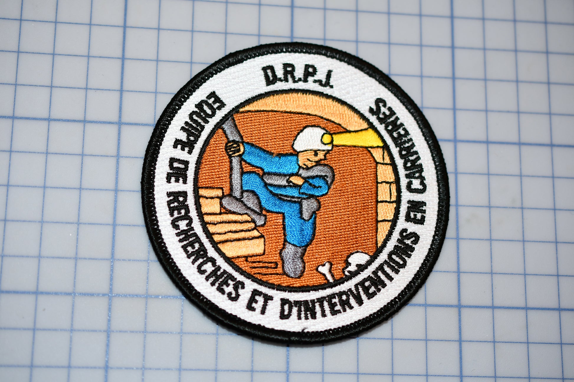 a patch with a picture of a man holding a baseball bat