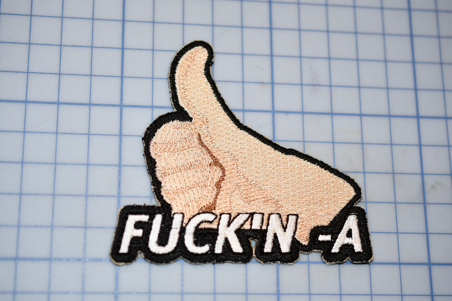 a patch with a thumbs up sign on it