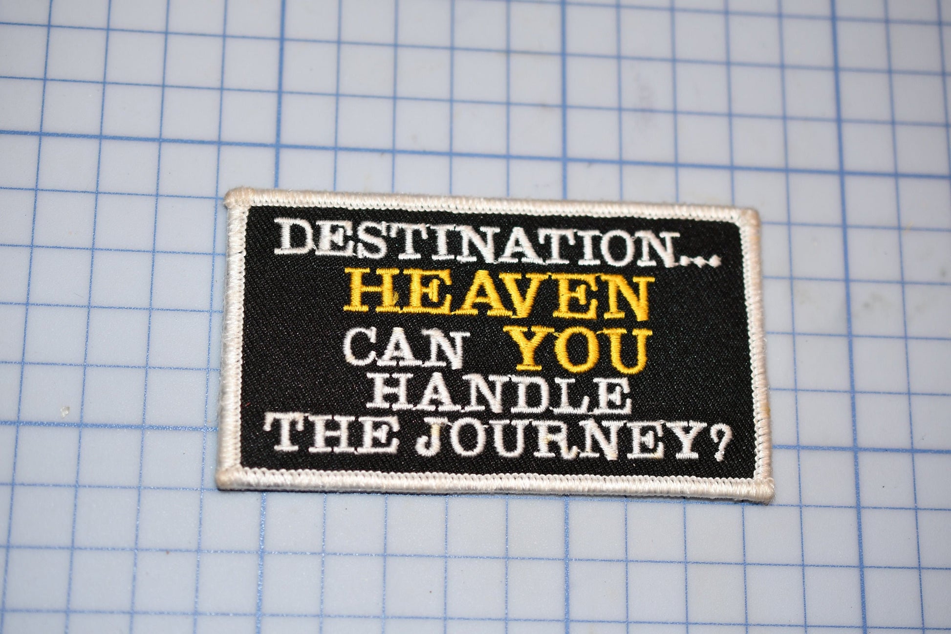 a black and white patch with a quote on it