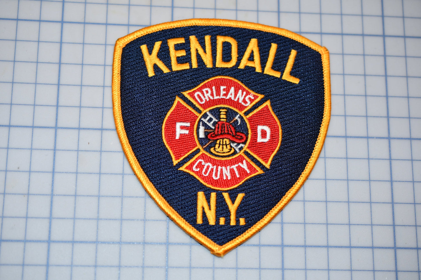 a kendall fire department patch on a piece of paper